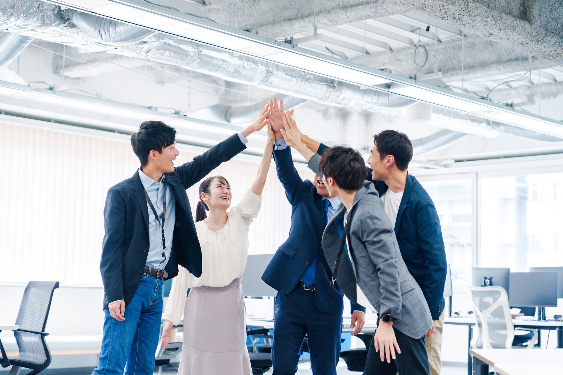 Business people giving high-fives at the office